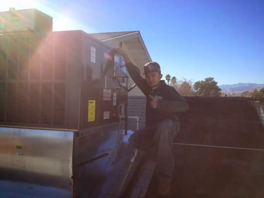 HVAC technician performing Heat Pump Repair on a rooftop unit in Diamond Bar